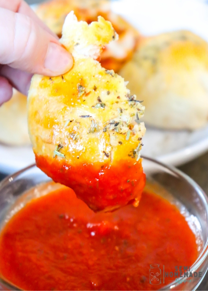 PIZZA STUFFED BISCUIT broken and dipped into pizza sauce