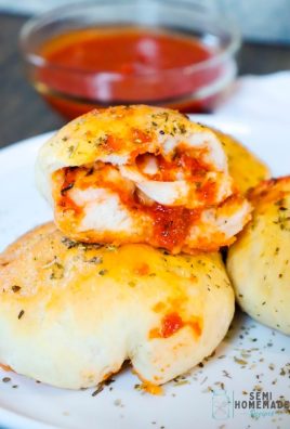 PIZZA STUFFED BISCUIT broken apart with pizza sauce and cheese showing
