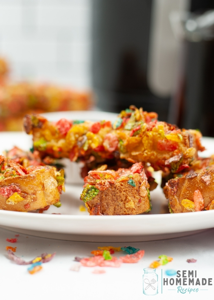 Air Fryer Fruity Pebbles French Toast Sticks on white plate with syrup