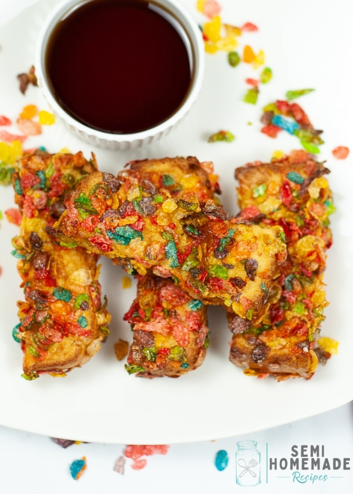 Air Fryer Fruity Pebbles French Toast Sticks on white plate with syrup