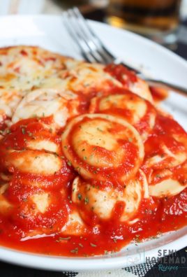baked ravioli with sauce in a white plate