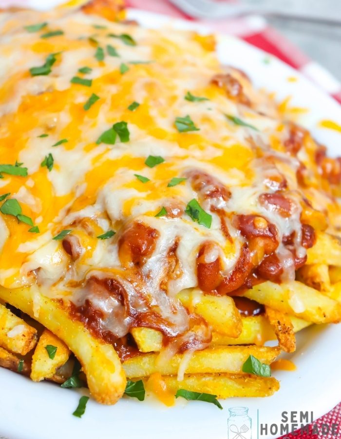 Easy Chili Cheese Fries – This dish is made with baked frozen French fries seasoned with seasoning salt and topped with chili sauce and chili beans Then it is topped with shredded cheese before being placed under the broiler to melt the cheese! Garnish with parsley and enjoy! Great with homemade ranch dressing!