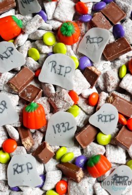 This Grave Yard Snack Mix is made with homemade muddie buddy chex mix, candy pumpkins, Halloween M&Ms, Kit Kats and homemade candy tombstones.