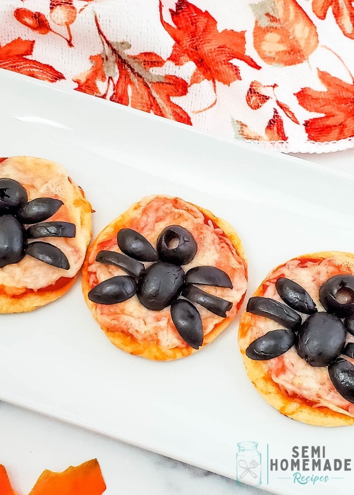 Mini Spider Pizza Bites are made with refrigerated crescent rolls, pizza sauce, shredded mozzarella cheese and black olive spiders! 