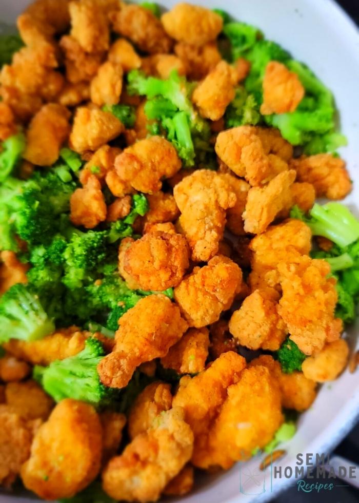 Cooked Popcorn Chicken and Steamed Broccoli in Skillet (1)