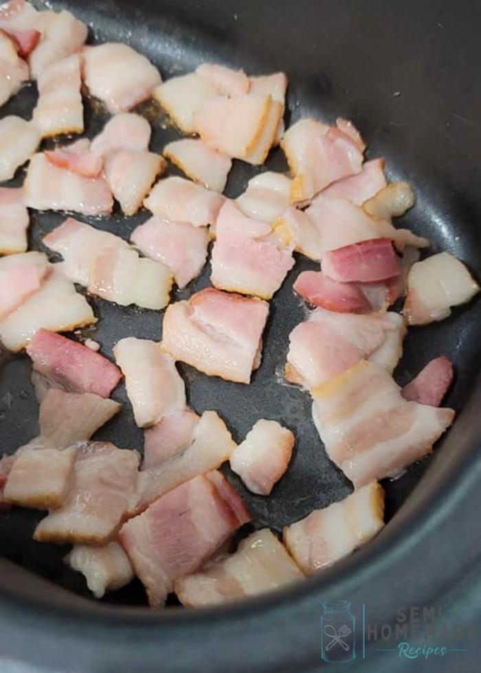 Raw bacon in bowl of black slow cooker