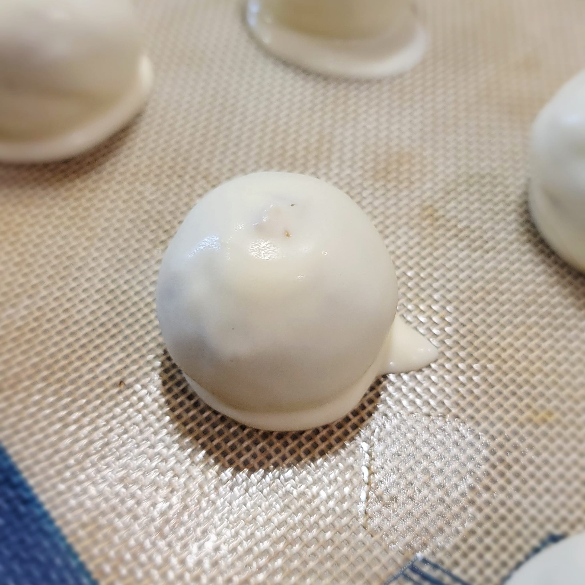 carrot cake ball covered in melting white chocolate