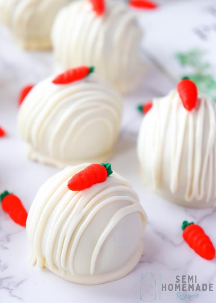 EASY CARROT CAKE TRUFFLES on white background with royal icing carrot
