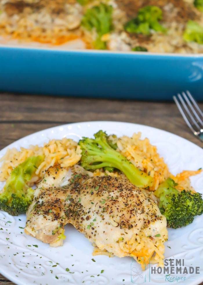 Oven-Baked-Chicken-Broccoli-Cheese-Rice-on-white-plate-with-blue-casserole-dish-in-background-(1)
