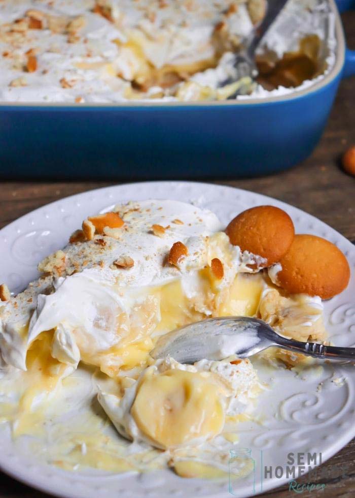half-eaten-Cold-Banana-Pudding-on-a-white-plate-with-blue-casserole-dish-in-background
