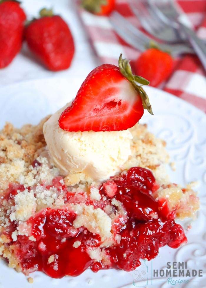 Semi Homemade Strawberry Crisp with ice cream on white plate wit