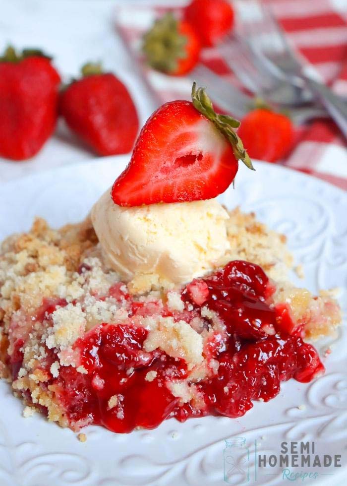 Semi Homemade Strawberry Crisp with ice cream on white plate wit