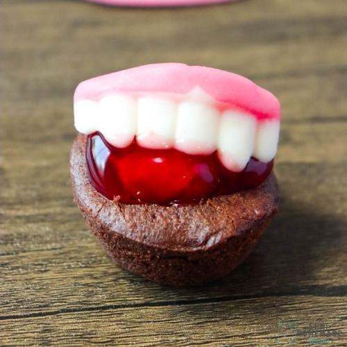 Brownie Bite add cherry and vampire gummy fangs