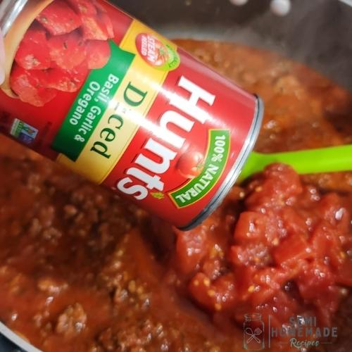 adding dice tomatoes to sauce