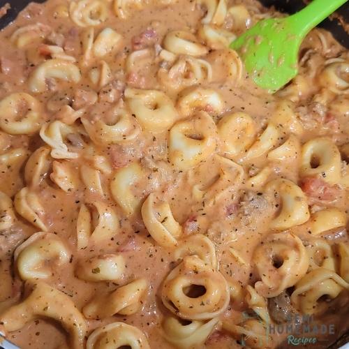 cooked tortellini mixed into pasta sauce