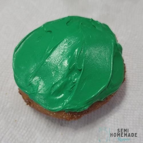 fried biscuit donut covered in green frosting