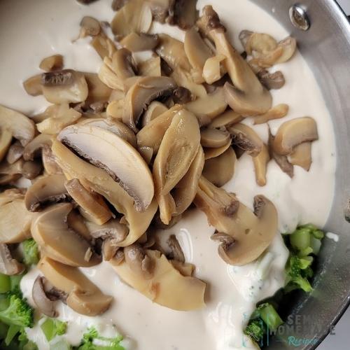 alfredo, broccoli and mushrooms in pan