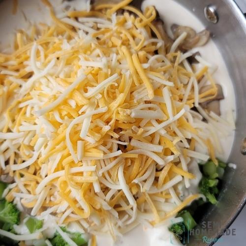 cheese on top of ingredients in pot