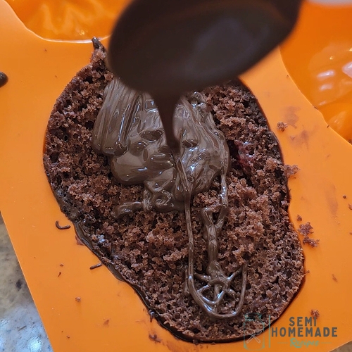 covering cake with chocolate