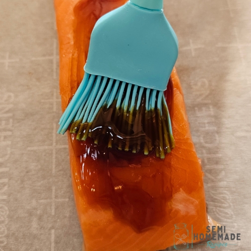 brush glaze onto salmon