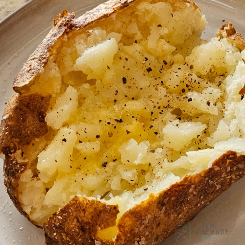 fluffed baked potato with butter salt and pepper
