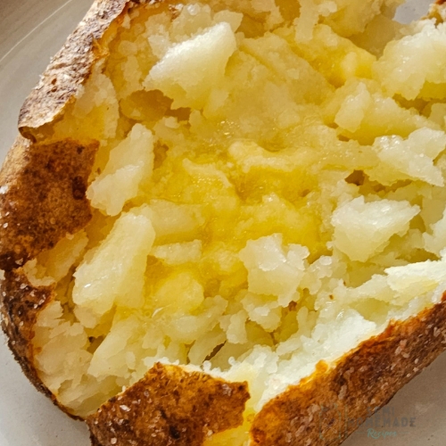 fluffed baked potato with butter